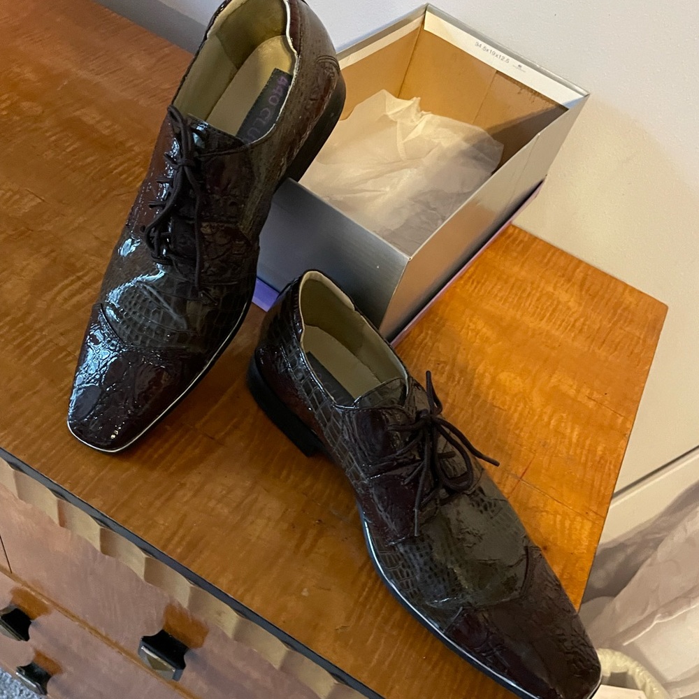 These shoes are by the 449 club. They are dark brown with an alligator surface.